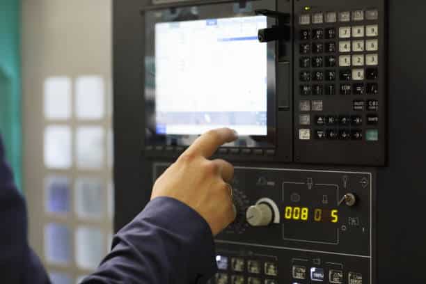 A programmer is programming for a CNC machine.