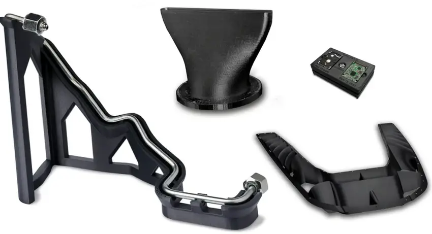Black 3D printed ABS plastic parts, including a structural bracket, a funnel, an electronics housing, and a curved component