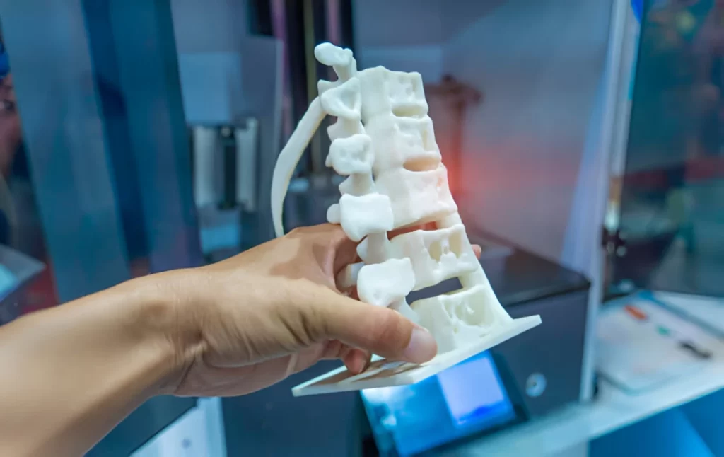 A man holding a 3D printed human spin prototype