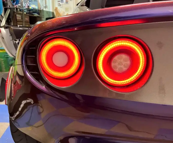 Circular 3D printed LED tail lights with red and amber ring patterns
