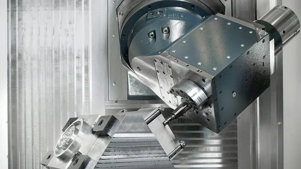 A close-up view of the axis machining process, the tool removing the material, and the workpiece is positioned at an inclined angle