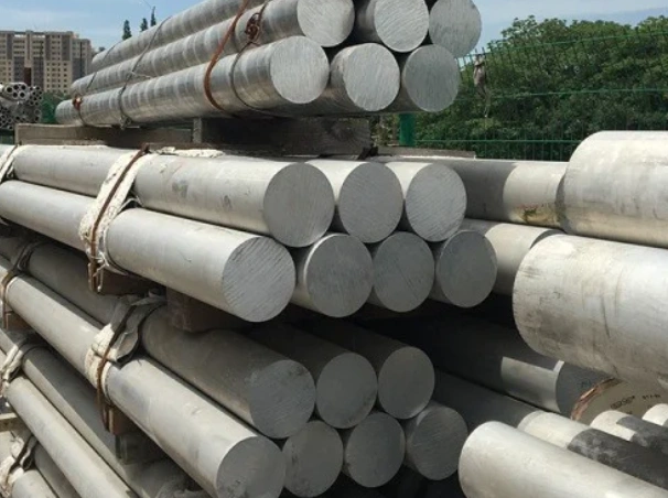 n image showing pipes of 7075 aluminum round bars in a factory yard ready for inspection