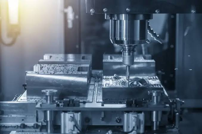 A CNC milling machine cutting through a workpiece