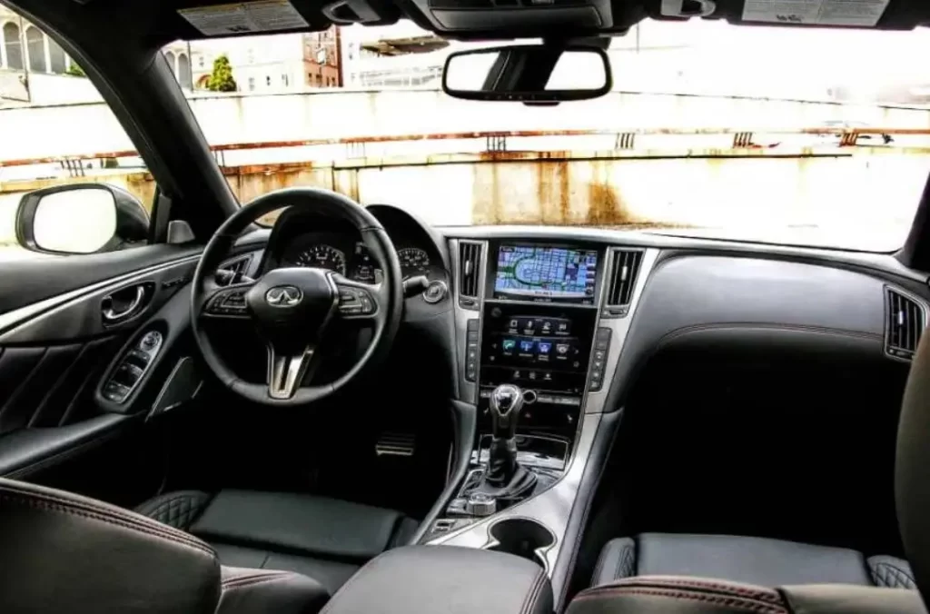 Automotive interior dashboard with ABS plastic trim, steering wheel, and center console components
