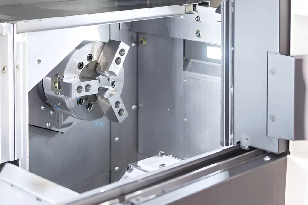 Large CNC lathe machine with a chuck for turning metal parts.