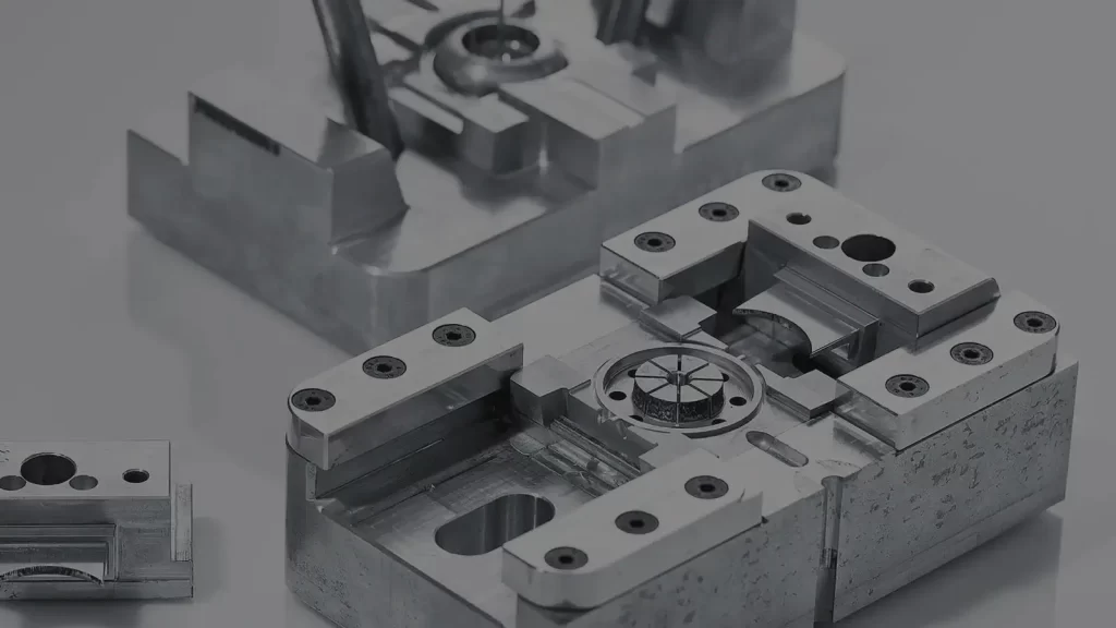 Alt text: Various black plastic automotive parts made using rapid tooling.