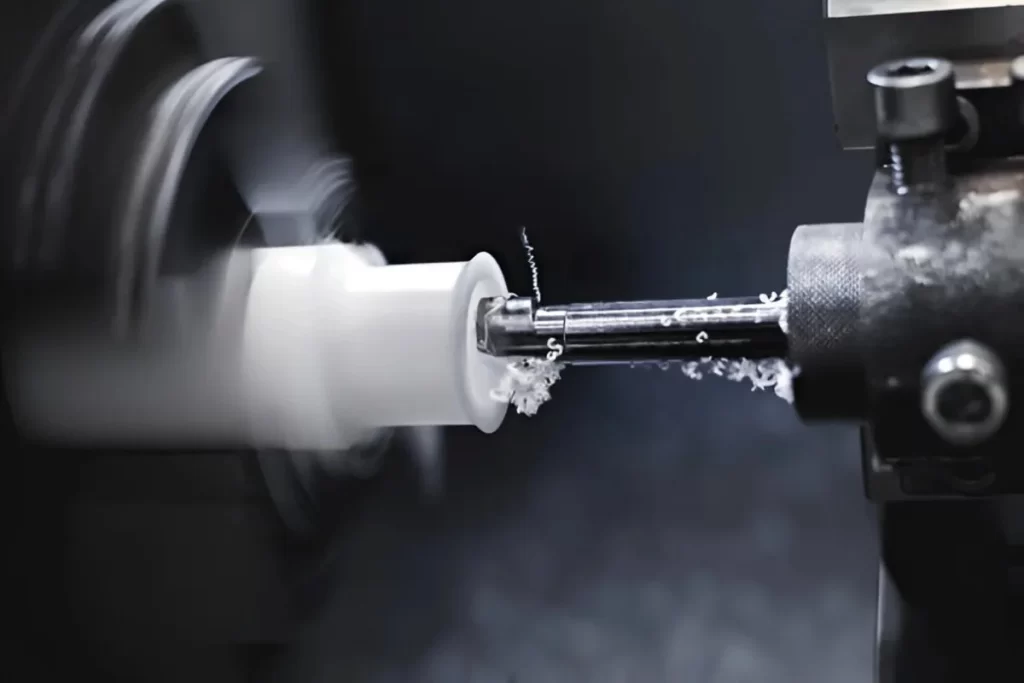 CNC plastic turning process showing a plastic part being machined on a lathe
