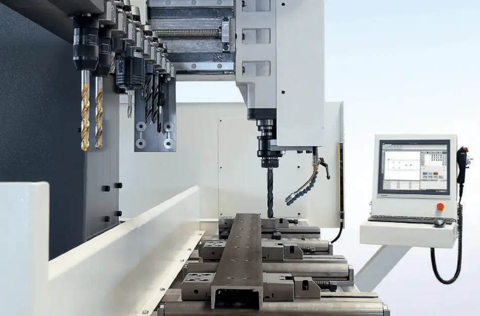An image of a section of a CNC drill showing several parts and a workpiece