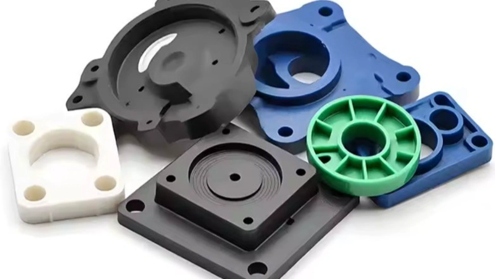 Collection of machined HDPE components, including mounting plates, flanges, and circular parts in white, black, blue, and green.