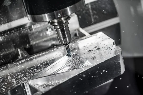 CNC end-mill creating shapes on stainless steel workpiece
