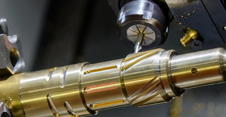 CNC machine machining precise grooves on a metal transmission shaft using profile milling