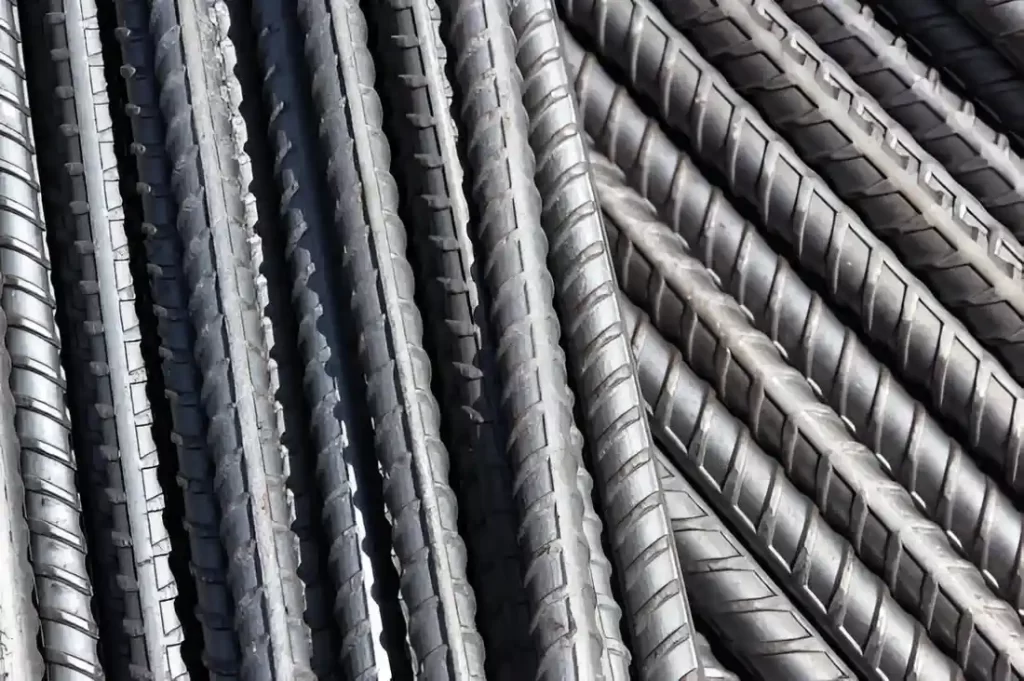 The image shows stacked carbon steel bar stock.