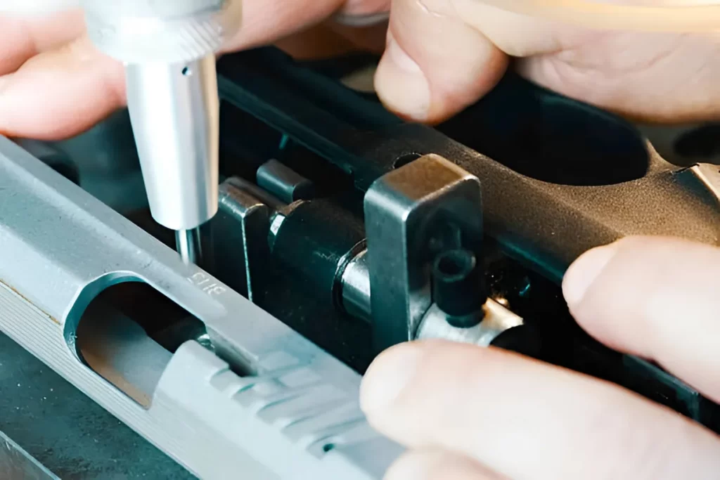 Close-up of a gun showing engraved code on its surface
