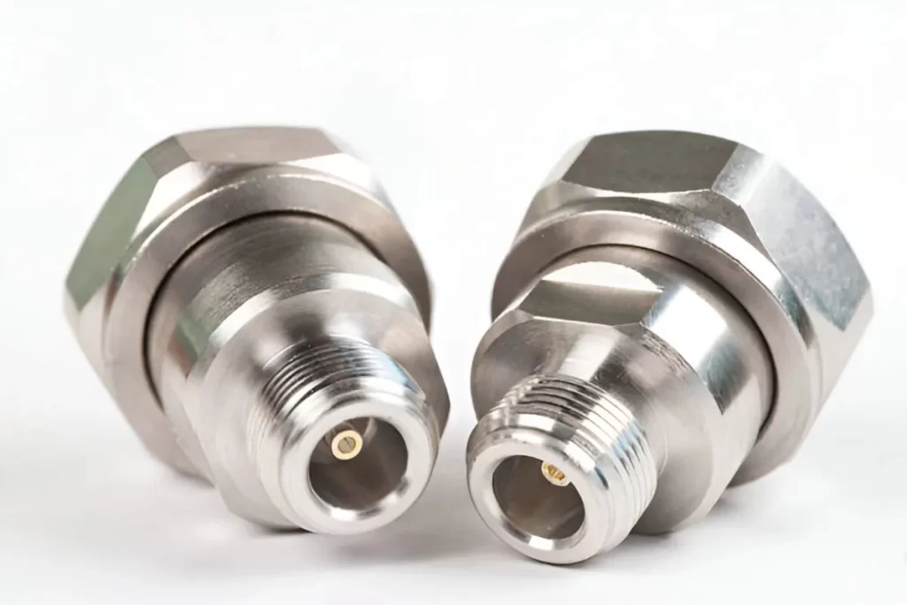 The image shows a pair of connector components with a shiny copper-nickel plating, displayed side by side.