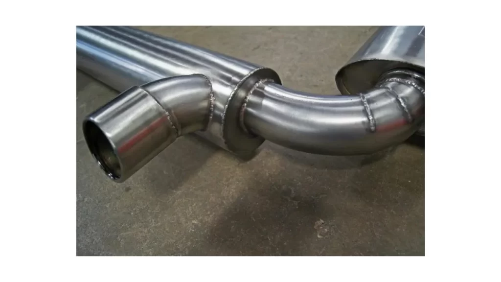 The image shows a custom exhaust system laid out neatly on the floor.
