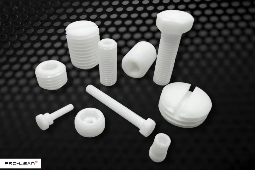 White plastic screws and fasteners, showcasing acetal/Delrin components in various shapes.