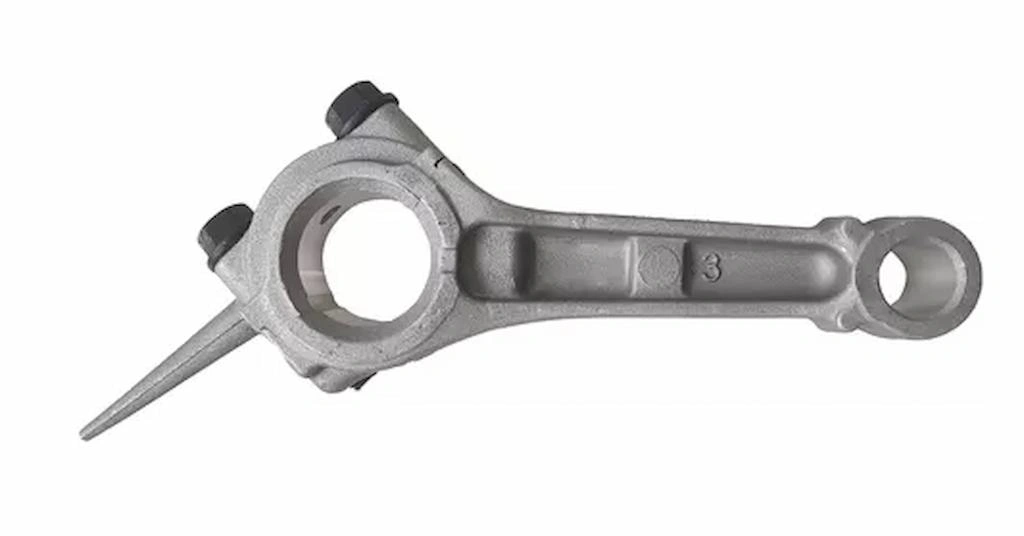 An image of a connecting rod just after being removed from the die casting mold.