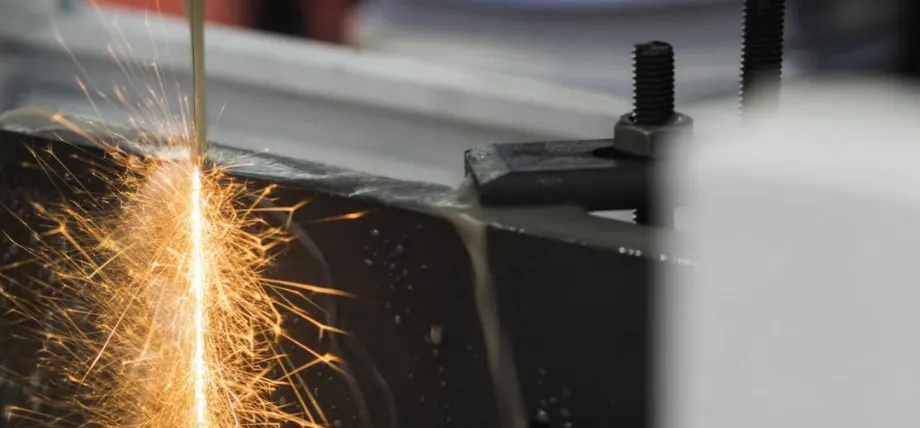 EDM wire cutting through material with spark erosions
