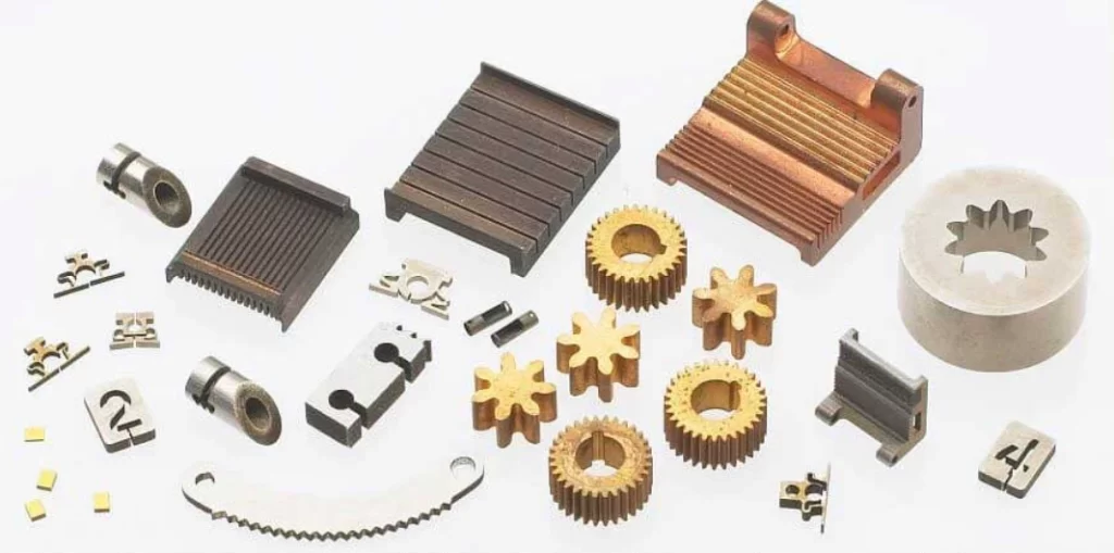 Collection of intricate metal parts, including gears and heat sinks, made by EDM