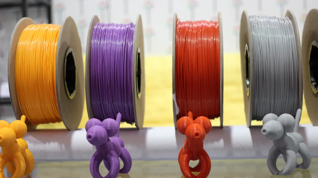 four different colored FDM printing filament rolls