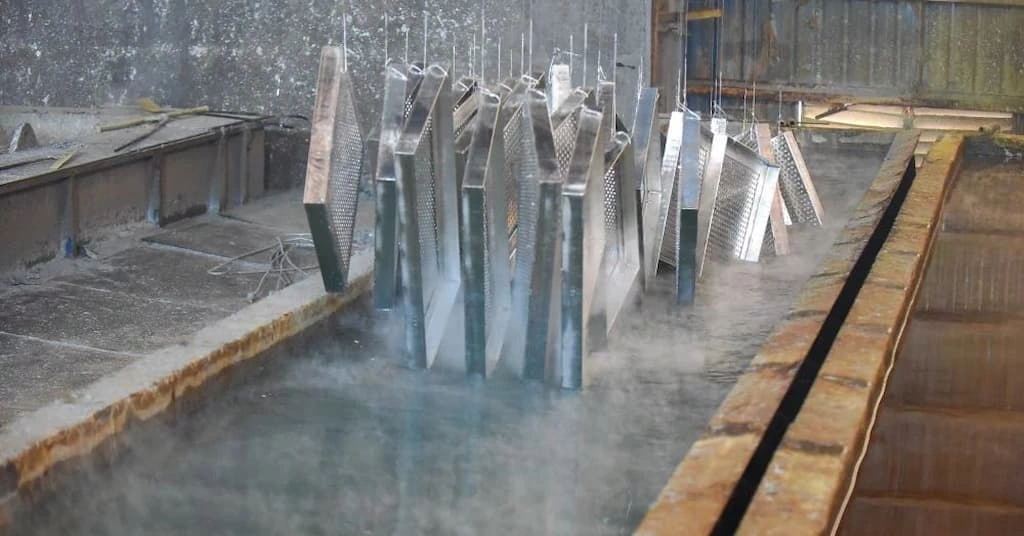 An image showing the process of hot-dip galvanization on steel parts for mechanical coating.