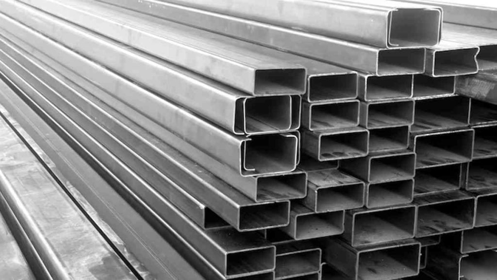 Black and white photo of stacked galvanized steel sections.