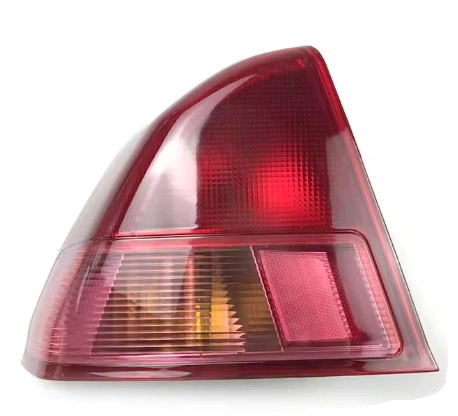 A close up view of a halogen tail light with a bulb inside the housing