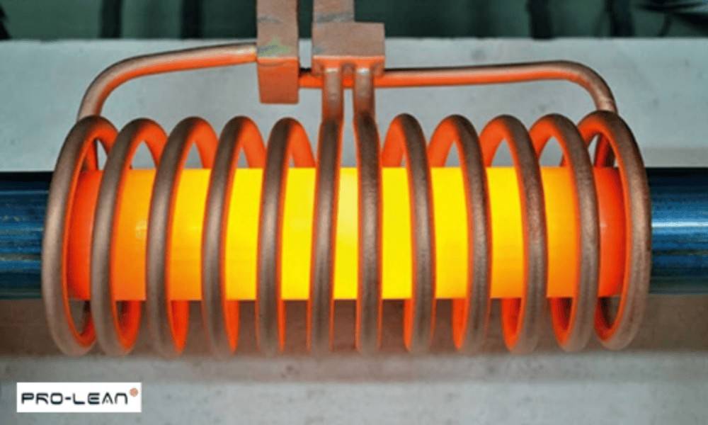 Glowing metal cylinder being heated by an induction coil, shows the induction heating process.