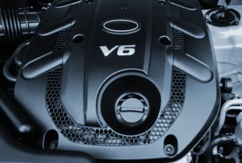 Black nylon engine cover on a V6 automotive motor showing impact-resistant and heat-resistant application