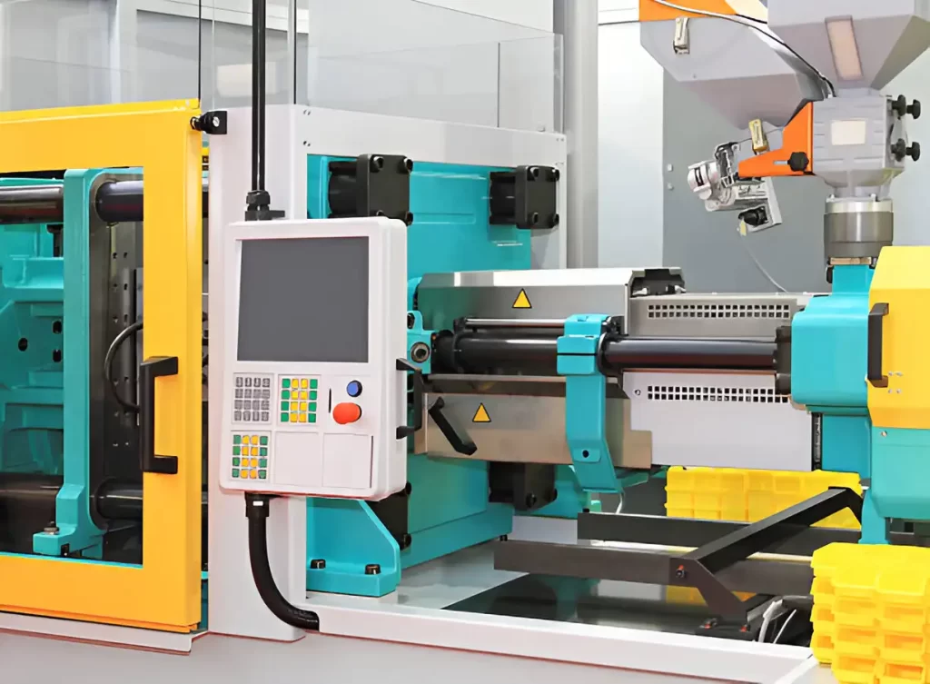 An industrial Injection Molding machine is shown in an industrial setting