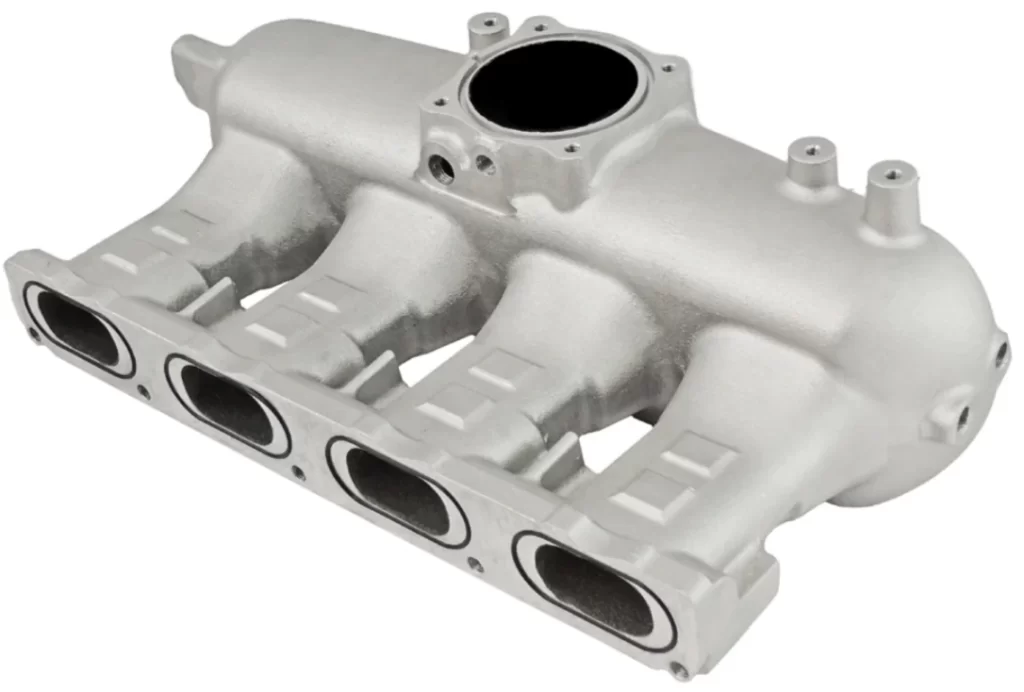 An image of a white intake manifold for a car