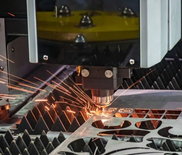 An image of a cutting process showing a laser cutting machine producing a sharp cut on a metal sheet