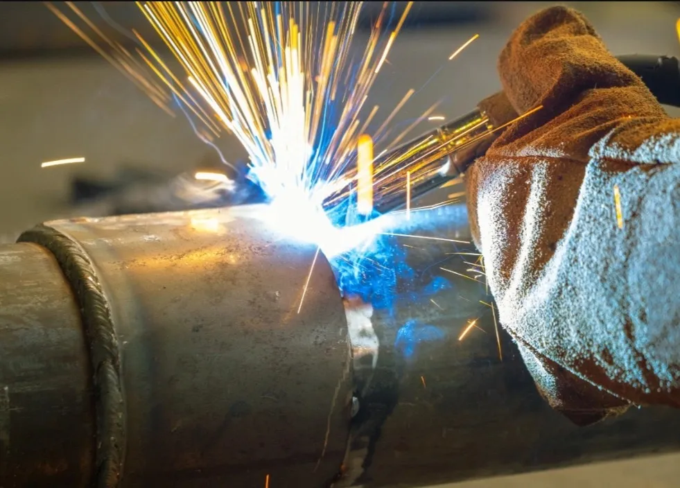 Bright sparks created during MIG welding of a 4140 steel pipe
