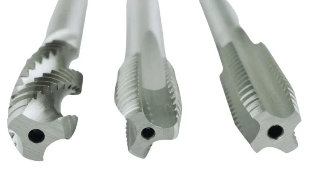 A close-up view of machine taps with different flute designs.
