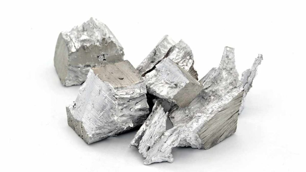 Irregularly shaped, silvery-white chunks of magnesium metal.