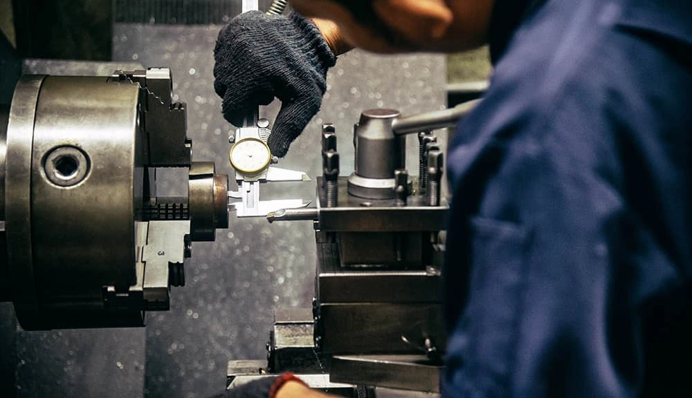 A close-up view of the operator calibrating the headstock and tailstock alignment