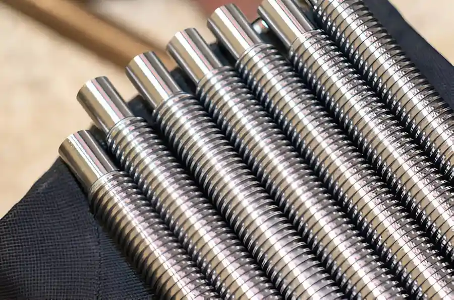 The image shows various metal-plated parts neatly arranged on a table for display.