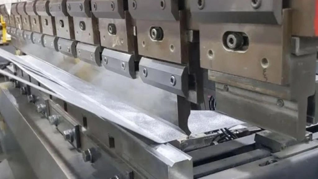 An illustration of the metal stamping process, showing progressive dies and punches