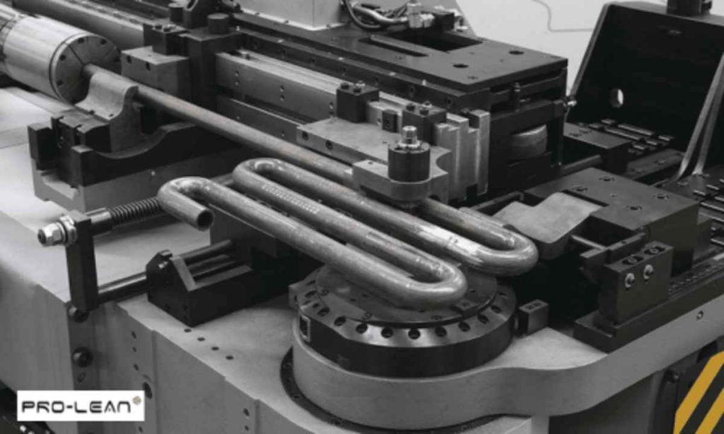 Industrial machine bending a metal tube into a complex, multi-loop shape.