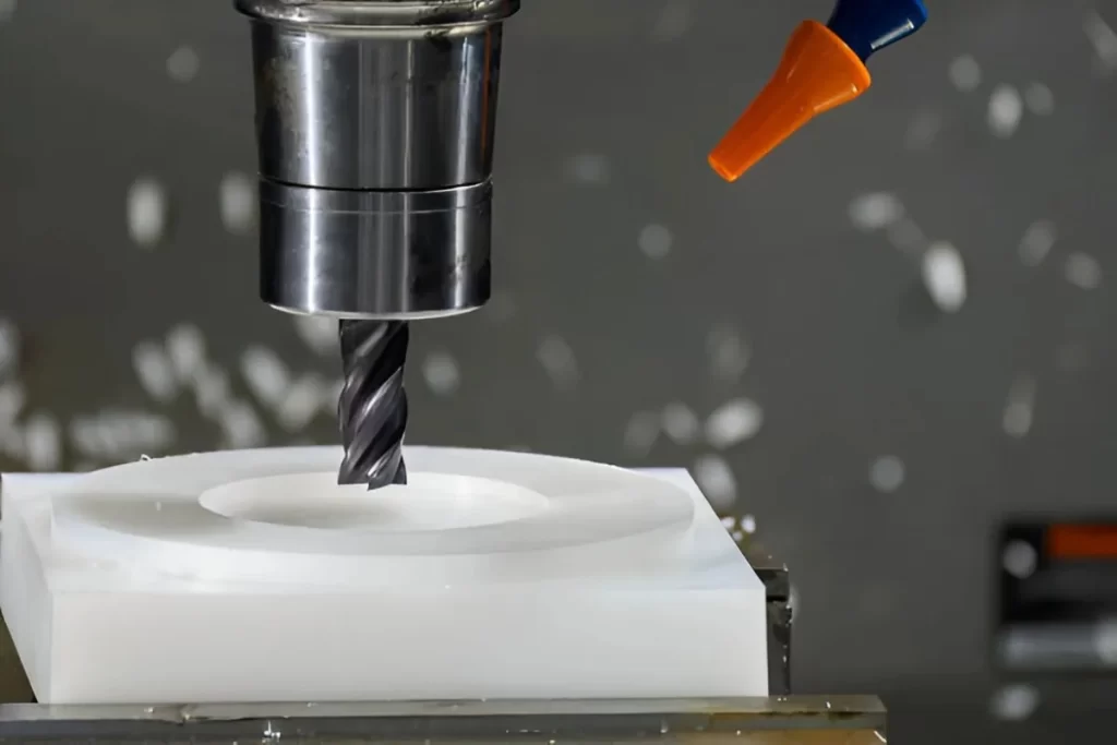 The image shows a nylon part being machined on a CNC setup.