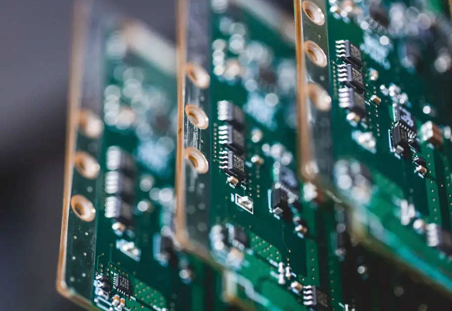 Green phenolic PCB boards with drilled holes and mounted electronic components