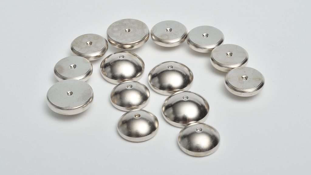 Nickel-plated metal components with polished reflective surface finishing.