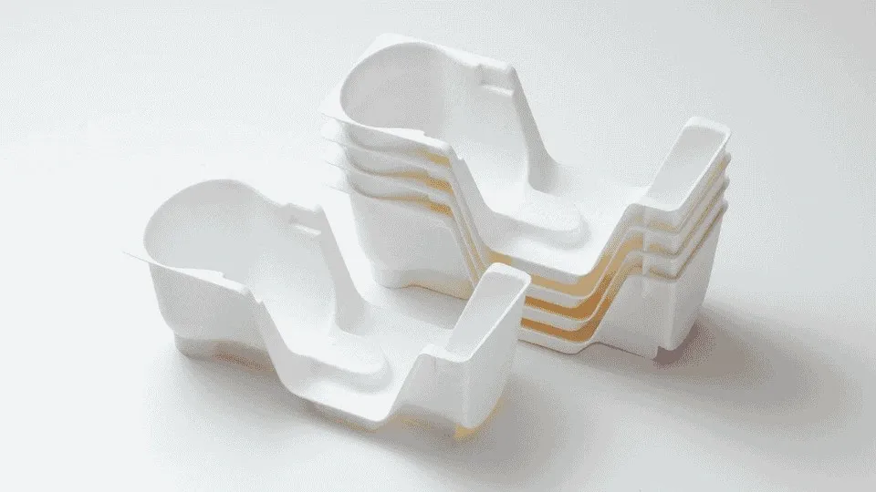 Injection molded product in white, shown in a simple and clear view.