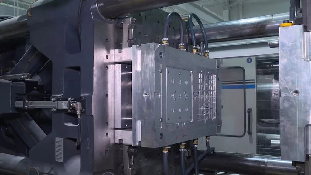 A close-up view of the injection molding setup in the factory