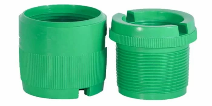 Two green-colored plastic fittings made from injection molding, external and internal threads