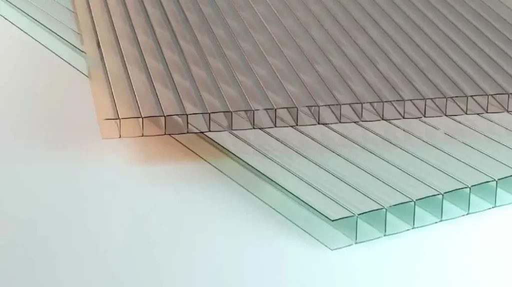 Image showing two sheets of polycarbonate plastic in light brown and green colors.