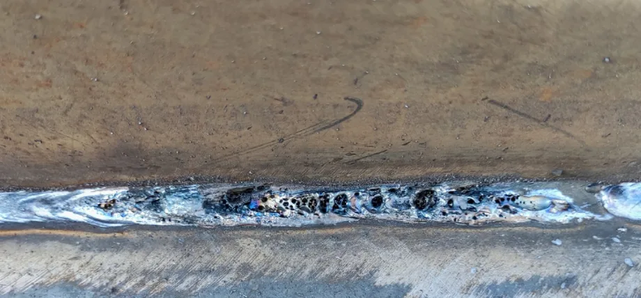Black holes visible on a silver welding seam
