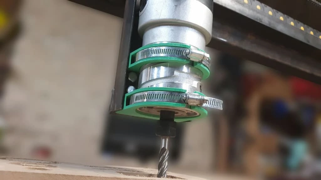 A close-up view of the CNC router spindle with a cutting tool attached to it.