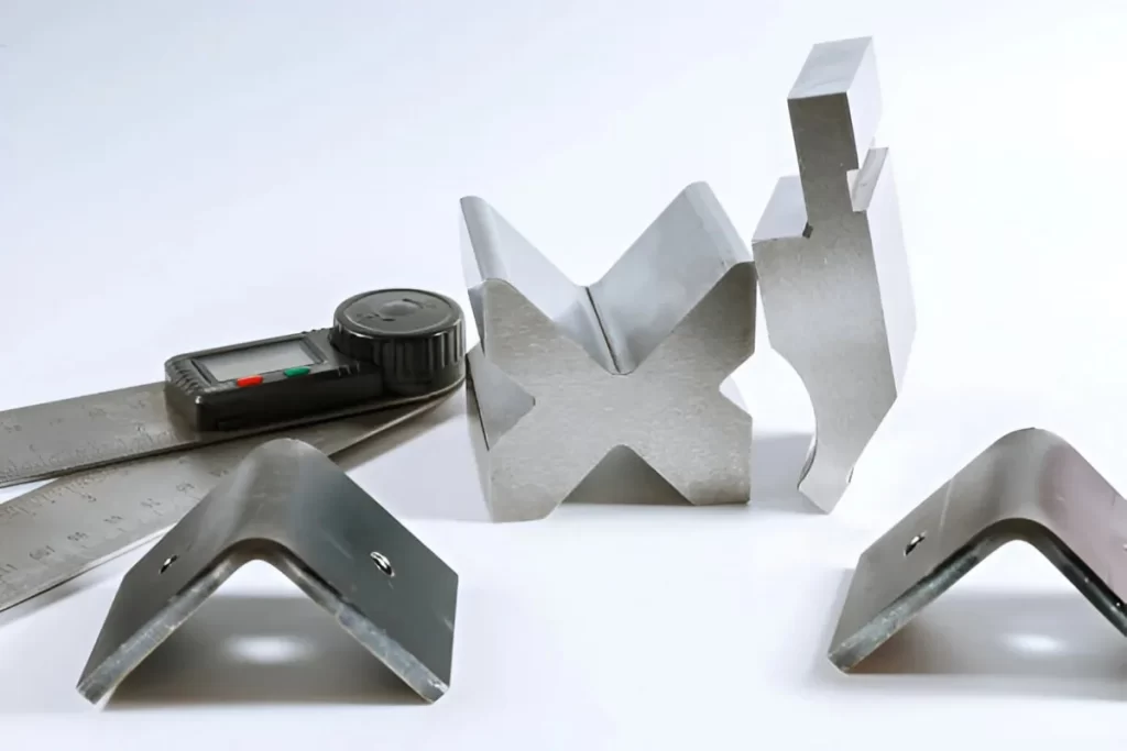 Image shows sheet metal bend prototypes displayed on a white background.