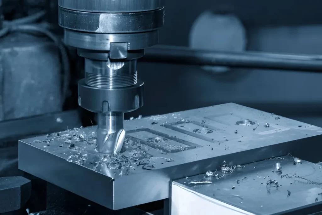 A spindle-mounted chuck holding a cutting tool while machining a metal part.